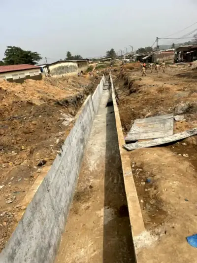 Caniveau en béton armé longeant les habitations du quartier